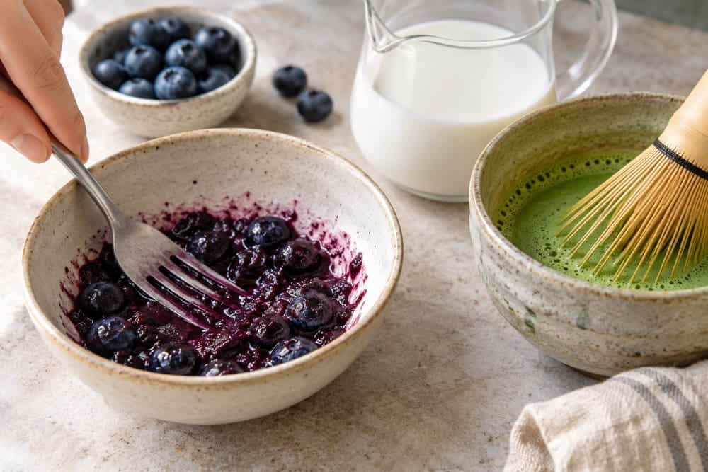 Blueberries crushed with a fork for a fruit base