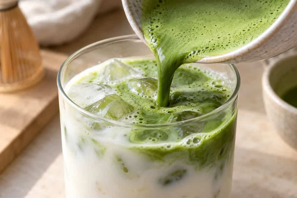 Matcha Cold Foam Latte With a Pourable Green Tea Top 2 Matcha cold foam poured over cold milk and ice